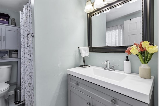 bathroom featuring toilet and vanity