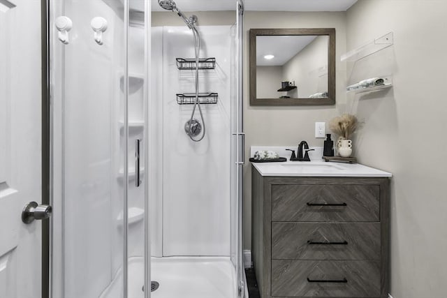 bathroom with a stall shower and vanity