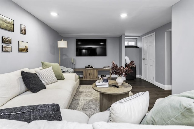 living area featuring wood finished floors, baseboards, and recessed lighting