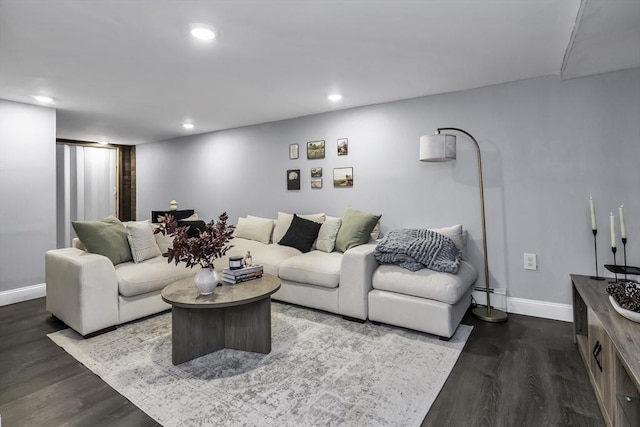 living area featuring dark wood-style flooring, baseboards, and recessed lighting