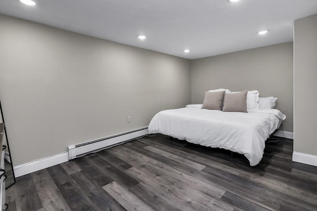 bedroom with a baseboard radiator, dark wood finished floors, baseboards, and recessed lighting