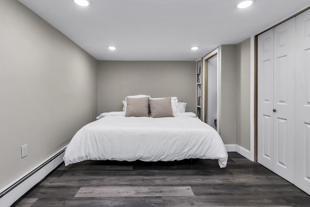 bedroom with a baseboard heating unit, recessed lighting, a closet, dark wood-style floors, and baseboards