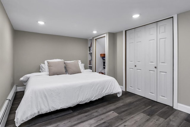 bedroom featuring baseboards, dark wood-style floors, a closet, a baseboard heating unit, and recessed lighting