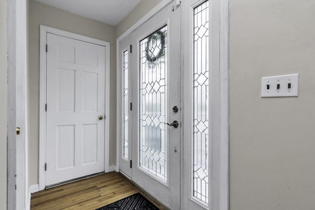 foyer with wood finished floors and baseboards
