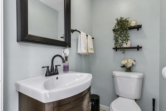 half bathroom with toilet and vanity