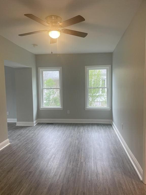 15 Forest St, Whitman, MA 02382 - unfurnished room with dark wood-type flooring, healthy amount of natural light, and baseboards
