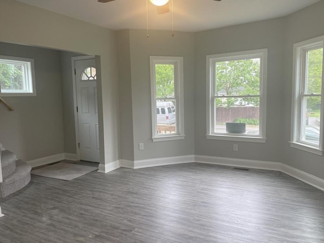 15 Forest St, Whitman, MA 02382 - unfurnished living room with dark wood-style floors, a ceiling fan, stairs, and baseboards