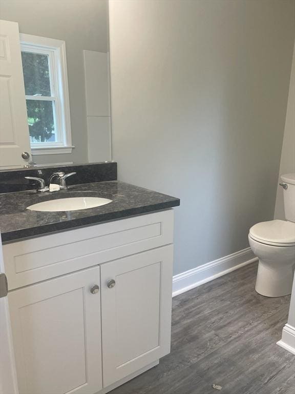15 Forest St, Whitman, MA 02382 - bathroom with toilet, vanity, baseboards, and wood finished floors