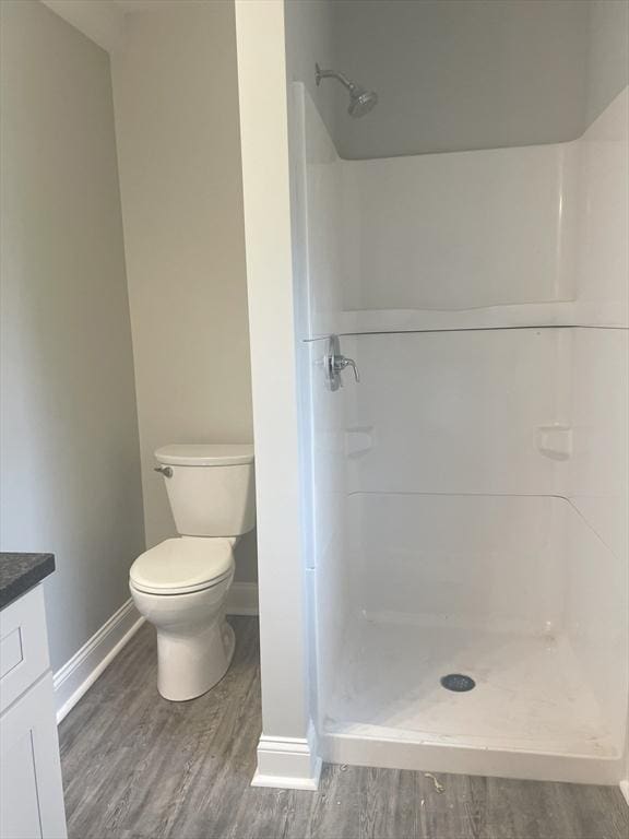15 Forest St, Whitman, MA 02382 - bathroom with wood finished floors, baseboards, toilet, and vanity