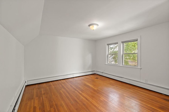 36 Kings Bch, Swampscott, MA 01907 - empty room with baseboard heating, wood finished floors, vaulted ceiling, and a baseboard radiator