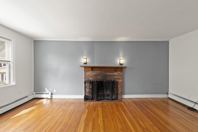 36 Kings Bch, Swampscott, MA 01907 - unfurnished living room featuring wood finished floors, a fireplace, baseboard heating, a baseboard heating unit, and baseboards