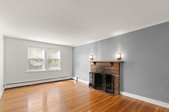 36 Kings Bch, Swampscott, MA 01907 - unfurnished living room with a baseboard radiator, a fireplace, wood finished floors, crown molding, and baseboards