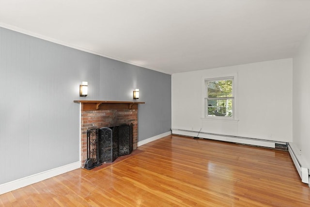 36 Kings Bch, Swampscott, MA 01907 - unfurnished living room featuring wood finished floors, a fireplace, a baseboard radiator, baseboards, and crown molding