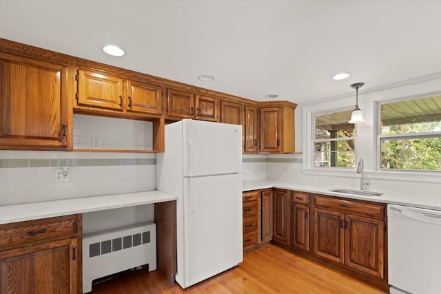 36 Kings Bch, Swampscott, MA 01907 - kitchen with white appliances, radiator, a sink, backsplash, and light wood finished floors