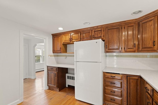 36 Kings Bch, Swampscott, MA 01907 - kitchen with freestanding refrigerator, radiator, a baseboard heating unit, light wood-type flooring, and light countertops