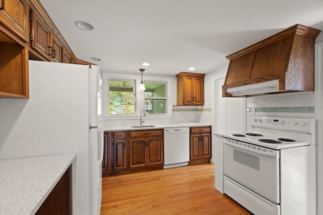 36 Kings Bch, Swampscott, MA 01907 - kitchen with white appliances, a sink, under cabinet range hood, light countertops, and light wood-style flooring