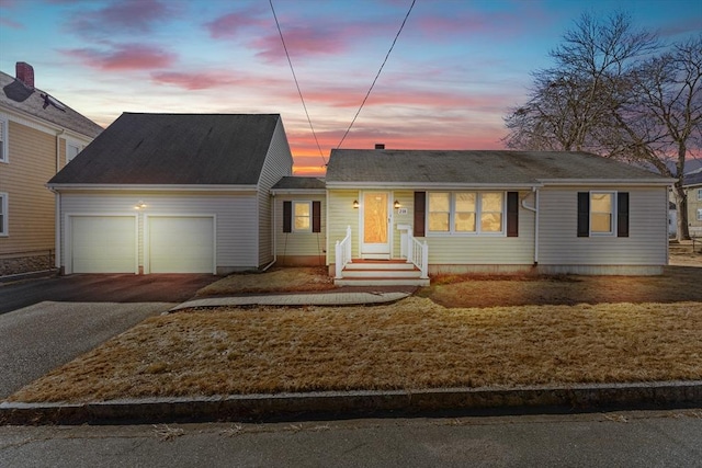 ranch-style house with an attached garage and driveway