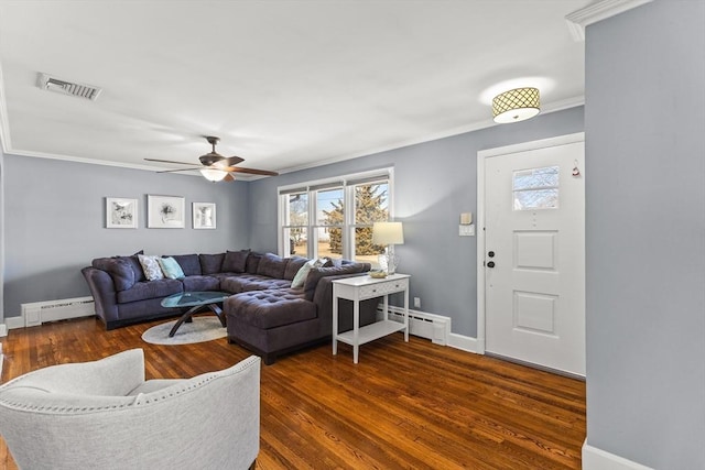 living room featuring visible vents, crown molding, baseboard heating, wood finished floors, and a baseboard radiator