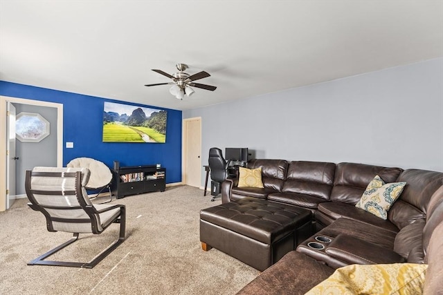 carpeted living area with baseboards and a ceiling fan