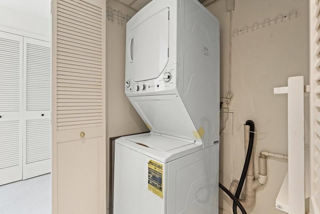 laundry room with stacked washer / dryer and laundry area