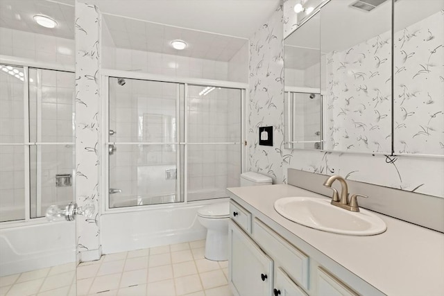 full bath featuring vanity, tile patterned floors, toilet, and enclosed tub / shower combo