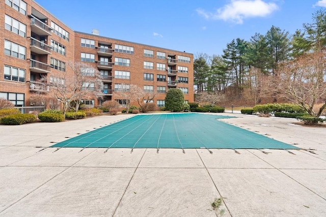 pool featuring a patio and fence