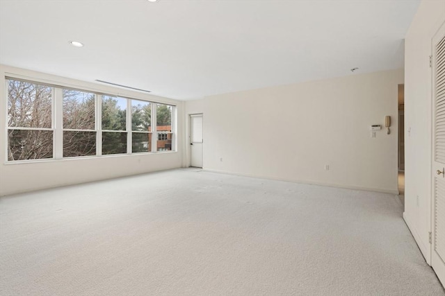 unfurnished room with recessed lighting and light colored carpet