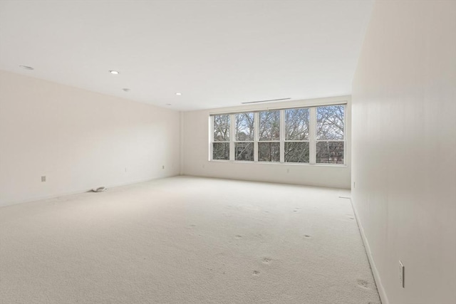 carpeted empty room with recessed lighting and baseboards