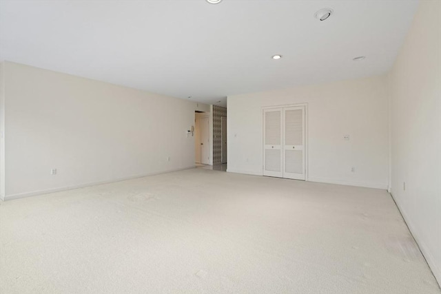 unfurnished room featuring recessed lighting and light carpet