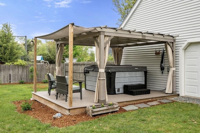 deck with a hot tub and a pergola