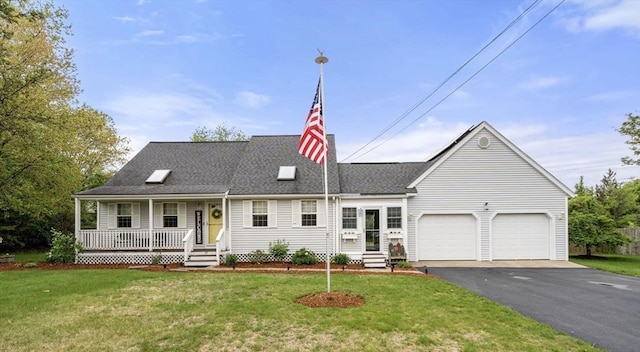 view of front of home with covered porch, driveway, a garage, and a front yard