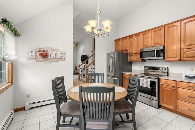 kitchen with stainless steel appliances, a baseboard heating unit, a chandelier, light countertops, and a towering ceiling