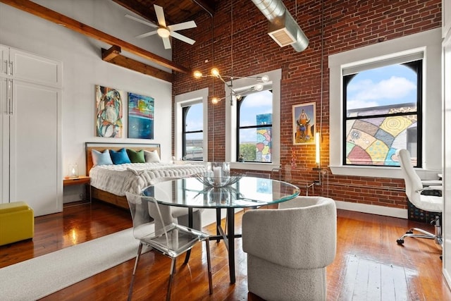 49 Munroe St Unit 405, Lynn, MA 01901 - bedroom featuring a towering ceiling, brick wall, and hardwood / wood-style floors
