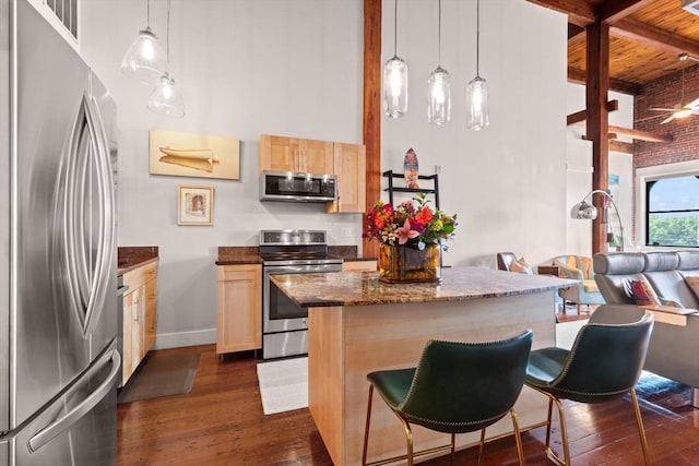 49 Munroe St Unit 405, Lynn, MA 01901 - kitchen with appliances with stainless steel finishes, a towering ceiling, light brown cabinets, dark wood-style flooring, and a kitchen breakfast bar