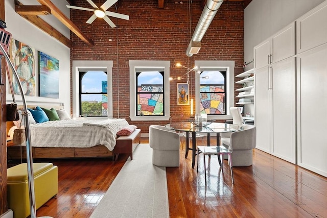 49 Munroe St Unit 405, Lynn, MA 01901 - bedroom with brick wall, a towering ceiling, and wood-type flooring