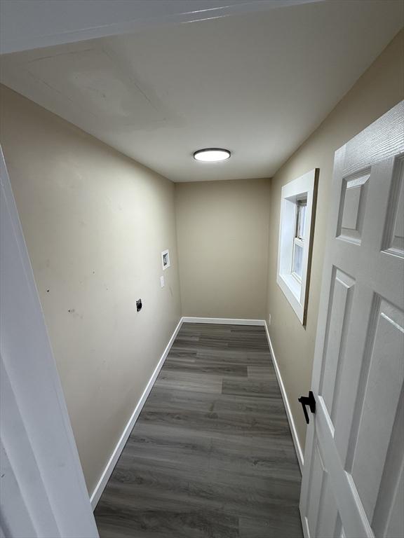 laundry room with baseboards and dark wood-style floors