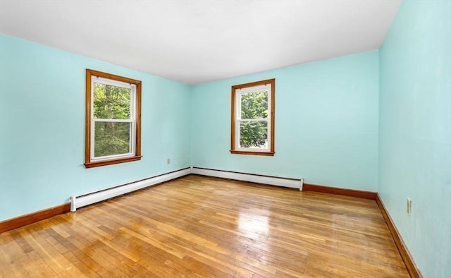 49 Whitman St, Weymouth, MA 02189 - spare room with plenty of natural light, a baseboard radiator, and hardwood / wood-style flooring