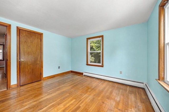 49 Whitman St, Weymouth, MA 02189 - unfurnished bedroom with light wood-style floors, a baseboard heating unit, baseboards, and baseboard heating