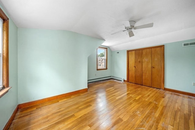 49 Whitman St, Weymouth, MA 02189 - unfurnished bedroom with baseboard heating, light wood-style flooring, lofted ceiling, and baseboards