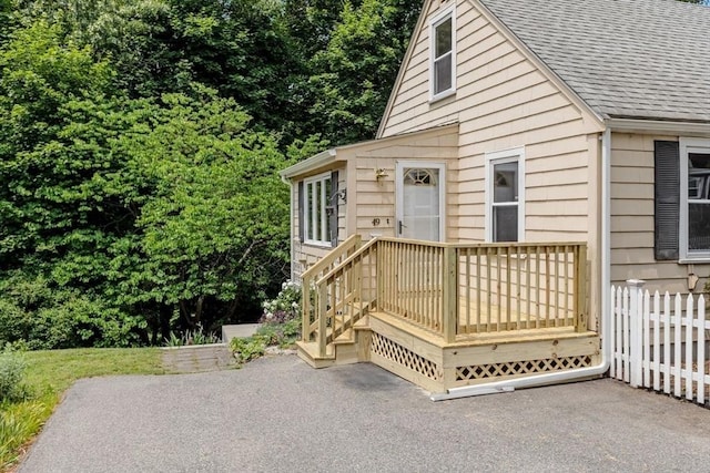 49 Whitman St, Weymouth, MA 02189 - view of front facade with a patio area, a wooden deck, and a shingled roof