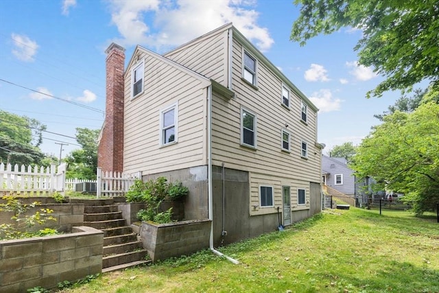 49 Whitman St, Weymouth, MA 02189 - rear view of house featuring a chimney