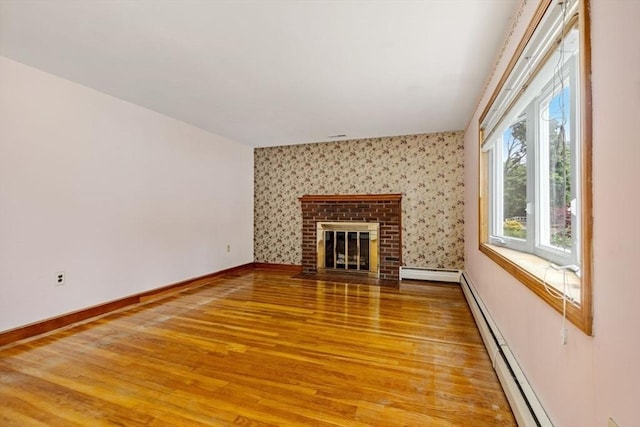 49 Whitman St, Weymouth, MA 02189 - unfurnished living room featuring baseboard heating, light wood finished floors, baseboards, a baseboard heating unit, and a fireplace