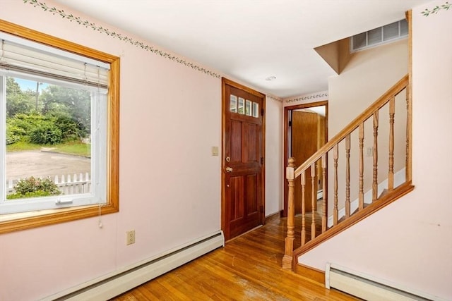 49 Whitman St, Weymouth, MA 02189 - foyer entrance featuring baseboard heating, a baseboard radiator, wood finished floors, and stairs
