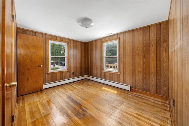 49 Whitman St, Weymouth, MA 02189 - unfurnished room with light wood-style flooring, plenty of natural light, wooden walls, and a baseboard heating unit