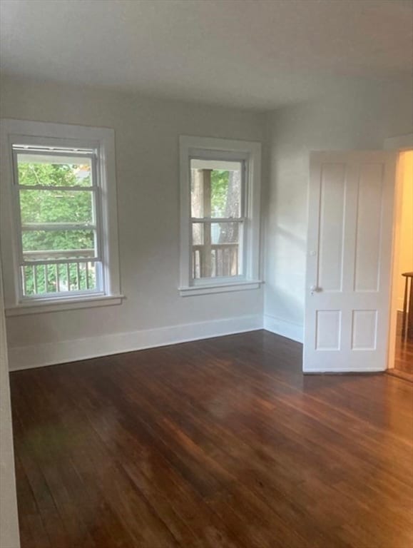 unfurnished room with dark hardwood / wood-style floors