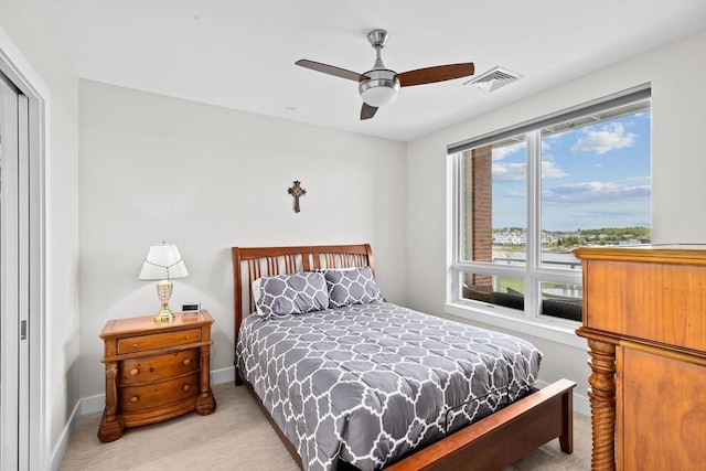 carpeted bedroom featuring a closet, a ceiling fan, and baseboards