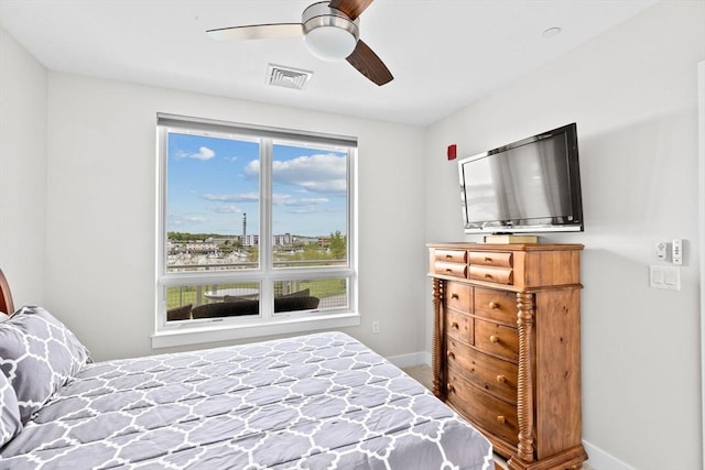 bedroom with baseboards, multiple windows, and a ceiling fan