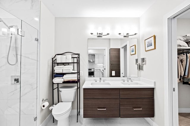 bathroom featuring a marble finish shower, marble finish flooring, double vanity, toilet, and baseboards