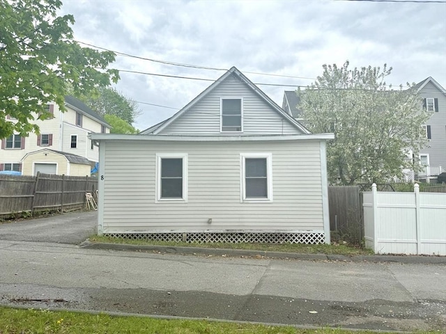 view of side of home with fence