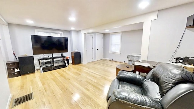 living area with wood finished floors, recessed lighting, and plenty of natural light